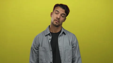 Hispanic man clapping over isolated yellow background wearing casual attire.. Stock Footage 313050897