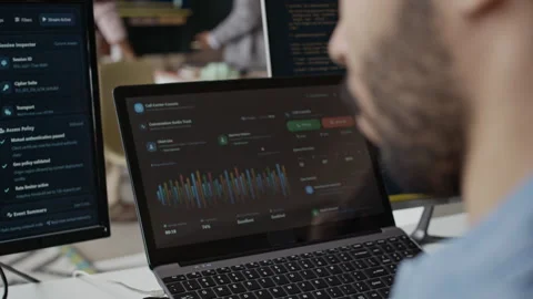 Hispanic Man Coding on Laptop with Desktop Monitor in Office Stock Footage 337481751