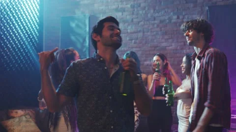 Hispanic man dance and drink alcohol on night party at bar. Video stock 166542694