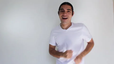 Hispanic man dancing like crazy very happy on a white background Video stock 192475397