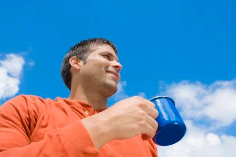 Hispanic man drinking coffee outdoors Stock Photos