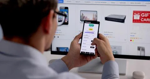 Hispanic Man Engaging With Mobile Loyalty Rewards App, Earning Points And Dis Stock Photos
