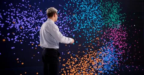 Hispanic Man Exploring Big Data Clustering Techniques On An Interactive Displ Stock Photos