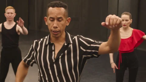 Hispanic Man Giving Ballroom Dance Class in Studio Stock Footage 246380211