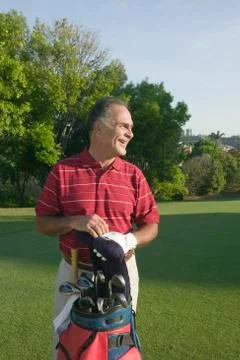 Hispanic man on golf course Photos