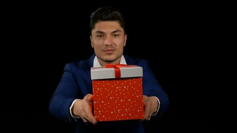 Hispanic man hands out his Christmas gift box Stock Footage 74678013