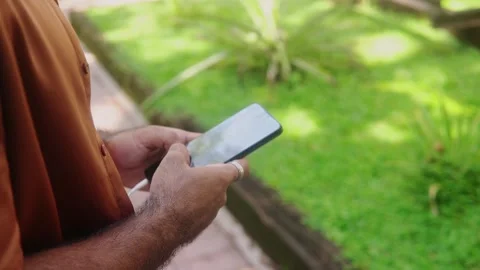 Hispanic man hands typing on smartphone outdoors Stock Footage 318012424