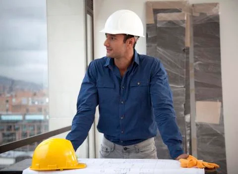 Hispanic man in hard-hat on construction site Stock Photos