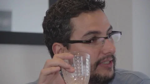 Hispanic man having conversation drinking wine Stock Footage 79097666