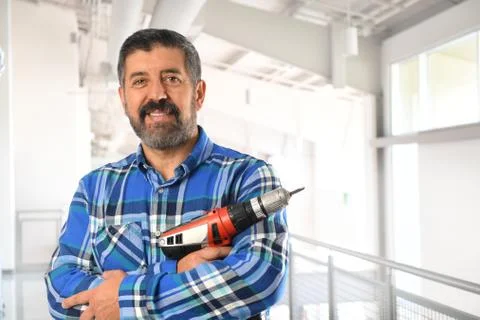 Hispanic Man Holding Drill Stock Photos
