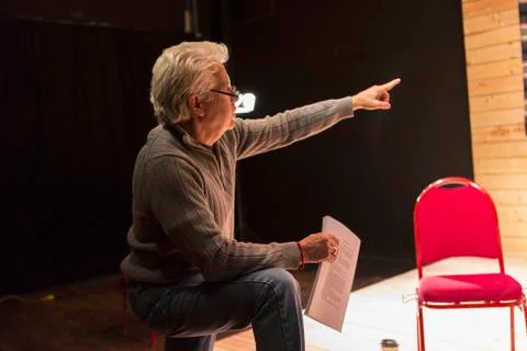 Hispanic man holding script pointing in theater Stock Photos