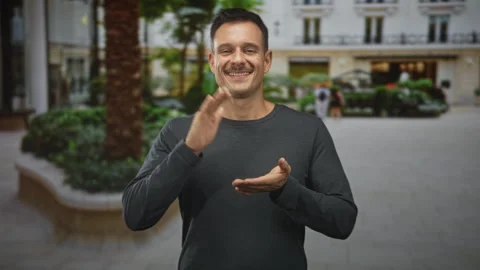 Hispanic man with moustache clapping hands and smiling in front of building.. Stock Footage 337390980