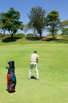 Hispanic man playing golf Stock Photos