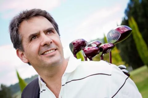 Hispanic man playing golf Photos