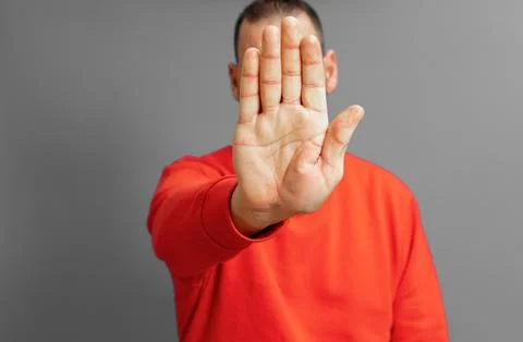Hispanic man putting hand in front to stop camera, rejecting photos or imag.. Stock Photos