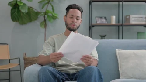 Hispanic Man Reading Documents at Home Video stock 293258029