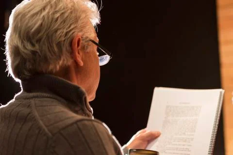 Hispanic man reading script in theater Stock Photos