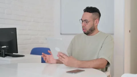 Hispanic Man Shocked by Loss on Tablet Video stock 307906704