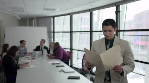 A Hispanic Man Stands Infront of Professionals in a Meeting (3 of 6) Stock Footage 47629635