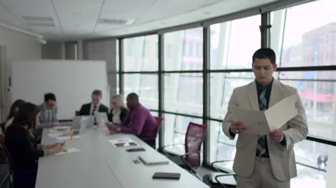 A Hispanic Man Stands Infront of Professionals in a Meeting (6 of 6) Stock Footage 47629759