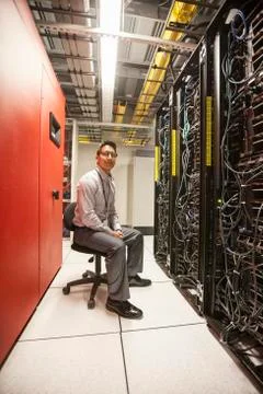 Hispanic man technician working with computer servers in a computer server farm. 스톡 사진