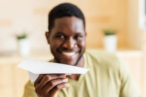 Hispanic man throw paper plane and sending a message Stock Photos