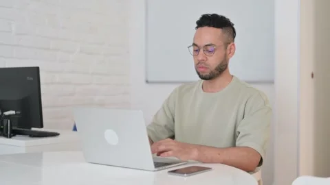 Hispanic Man Typing on Laptop for Work 動画素材 307903728