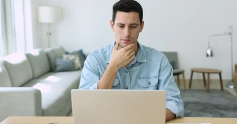 Hispanic man use laptop feels angry due to awful news Stock Footage 249866559