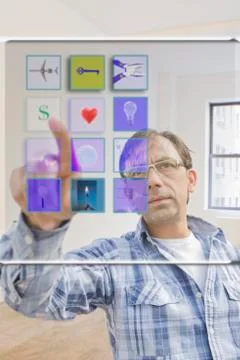 Hispanic man using mobile apps on virtual screen Stock Photos