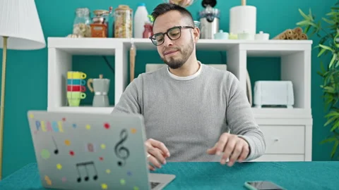 Hispanic man using smartphone sitting on table at dinning room Video stock 247384365