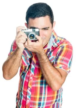 Hispanic man using a vintage looking compact camera Stock Photos