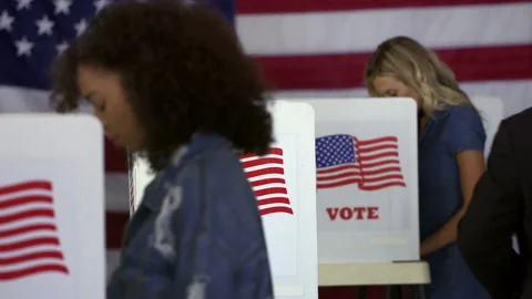 Hispanic man voting at booths at polling station HD Stock Footage 137755526