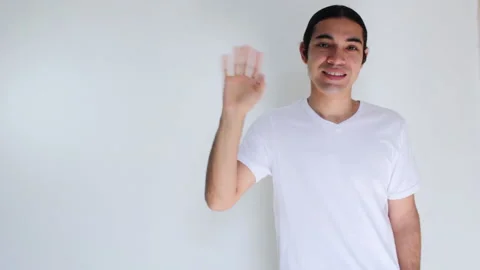 Hispanic man waving goodbye on a white background 動画素材 192465006