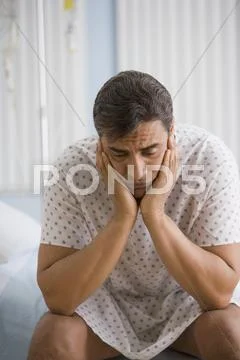 Hispanic man wearing hospital gown Stock Photos