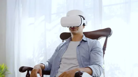 Hispanic man wearing virtual reality headset watching inside cyberspace Stock-Footage 166037715