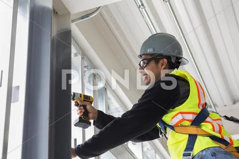Hispanic man working at construction site Stock Photos