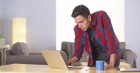 Hispanic man working on laptop and drinking coffee Video stock 42574677