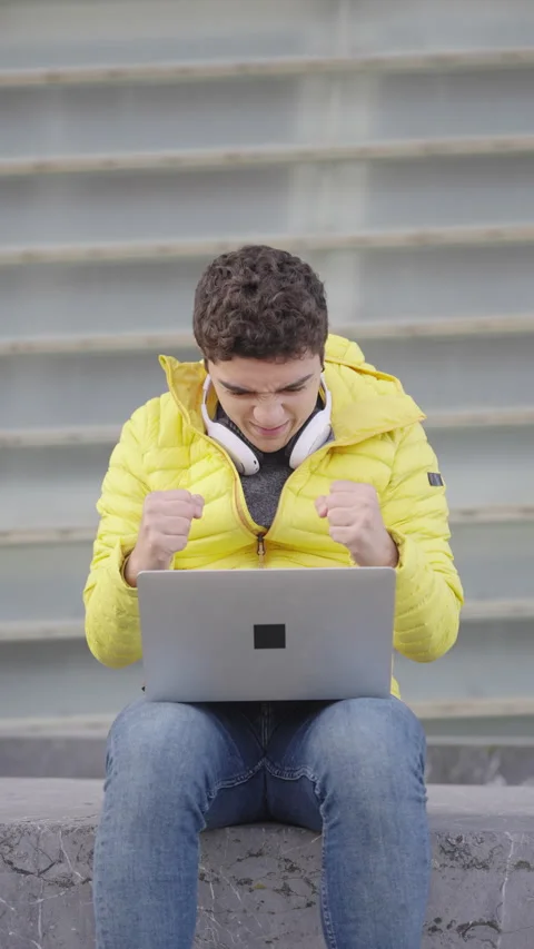 Hispanic man working on laptop, looking at camera and making ok sign Stock Footage 222566608
