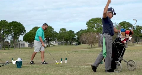 Hispanic men stretch and practice their golf swing Video stock 218230047