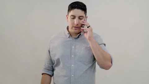 Hispanic middle-aged man in grey shirt having calm conversation on mobile phone Video stock 249218662