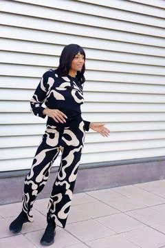 Hispanic modern dancer gesturing standing on street Stock Photos