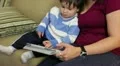Hispanic mom and young son using an electronic tablet HD Footage