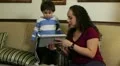 Hispanic mom showing her son something on a tablet HD Footage