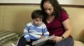 Hispanic mom with toddler using an electronic tablet HD Footage