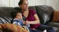 Hispanic mom watching TV with her son HD Footage