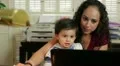 Hispanic mom working with baby HD Footage