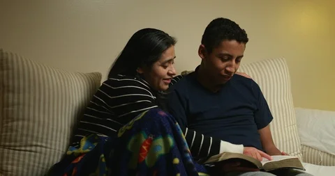 Hispanic Mother and Son Studying The Bible at Home Stock Footage 103187652