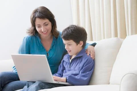 Hispanic mother and son using laptop 스톡 사진