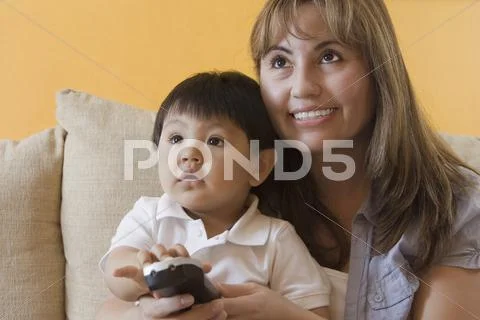 Hispanic Mother And Son Watching Television