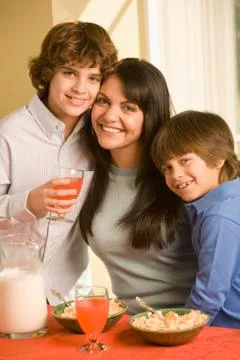 Hispanic mother and sons eating breakfast Stock Photos